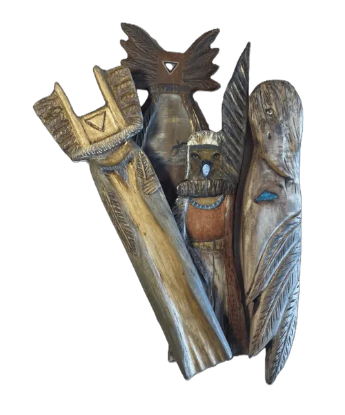 A group of hand-carved and painted wooden talismans
